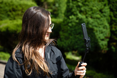 Midsection of woman holding umbrella