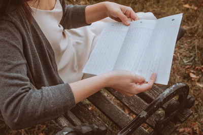 Midsection of woman reading letter