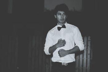 Man standing in bow tie at dusk