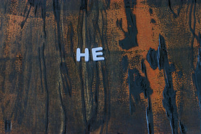 Close-up of text on wooden table