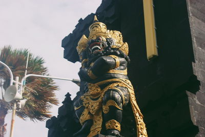 Low angle view of statue against building