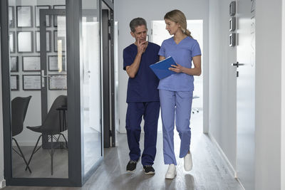 Nurse and doctor walking in corridor