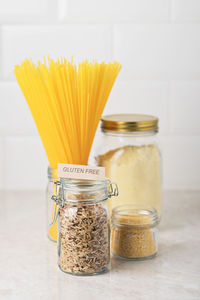 Gluten-free pasta and cereals in a glass jar on the table. 