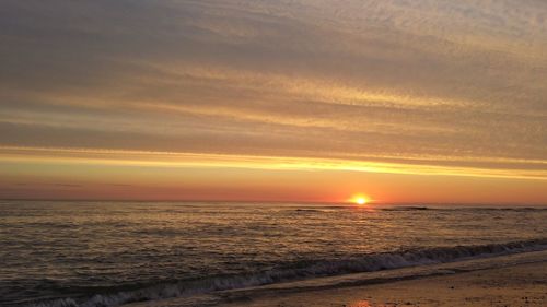 Scenic view of beach against sky during sunset