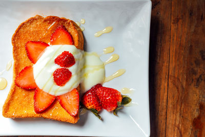 Close-up of strawberries in plate on table