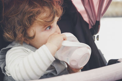 Portrait of cute boy drinking coffee