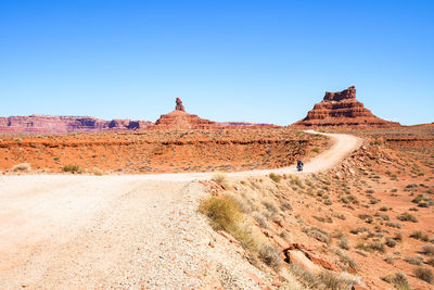 Scenic view of desert against clear blue sky