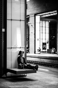 Side view of a boy sitting on floor