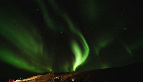 Low angle view of illuminated light against black background