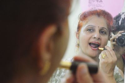 Portrait of happy young woman holding camera