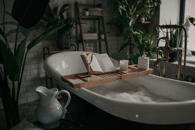 Luxury interior of big bathroom at modern african style with oval bathtub in natural lighting