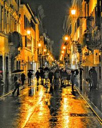 Illuminated street lights in city at night