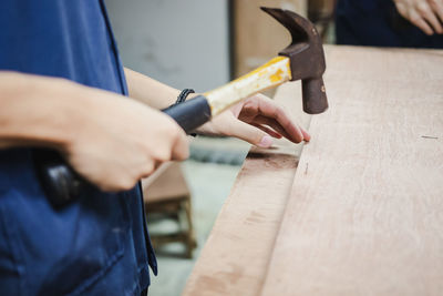 Midsection of man working on table