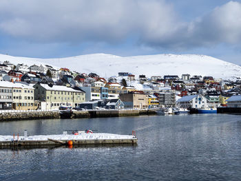 Honningsvag in mageroya island, finnmark, norway, in winter with a snow capped mountain backdrop