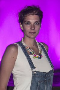 Portrait of beautiful woman standing against pink wall