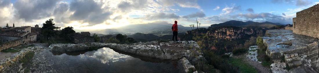 Panoramic view of trees and mountains against sky