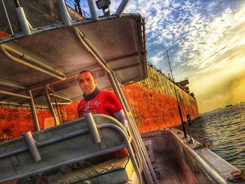 Low angle view of man on boat against sky