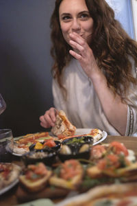 Young woman having pizza at food in restaurant