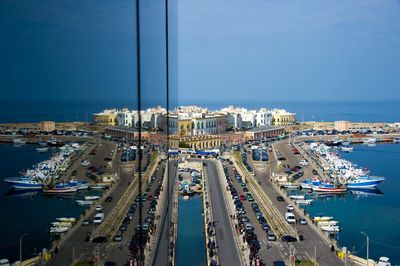 Panoramic view of harbor against sky in city