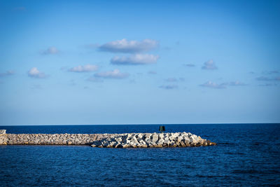 Sailboats in sea against sky