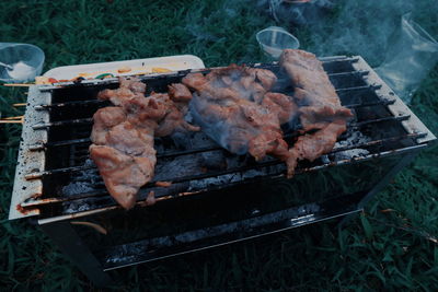 High angle view of meat on barbecue grill