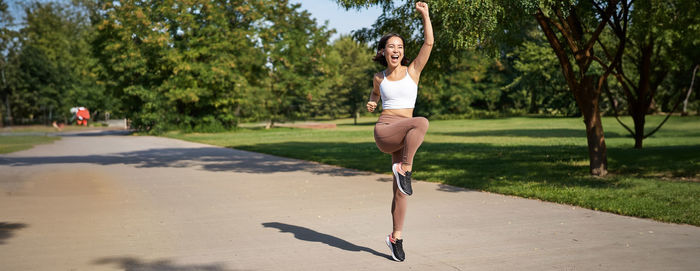 Full length of young woman exercising in park