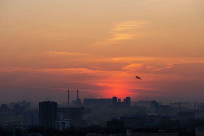 Low angle view of cityscape against sky during sunset
