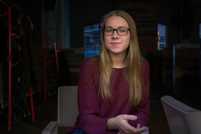 Portrait of smiling young woman sitting at cafe