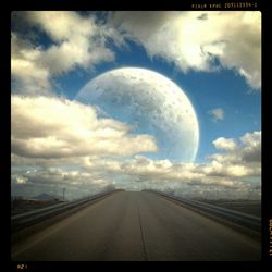 View of country road against cloudy sky