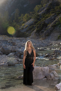 Full length of woman standing on rock