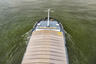 A barge carrying coal with a covered hold on the river rhine. transport of coal and solid fuel.