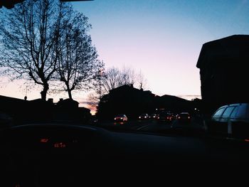 Cars on road at sunset