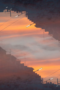 Low angle view of silhouette buildings against sky during sunset