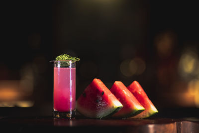 Close-up of fruits and drink on table