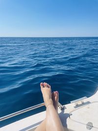 Low section of woman swimming in sea