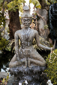 Statue of buddha against trees