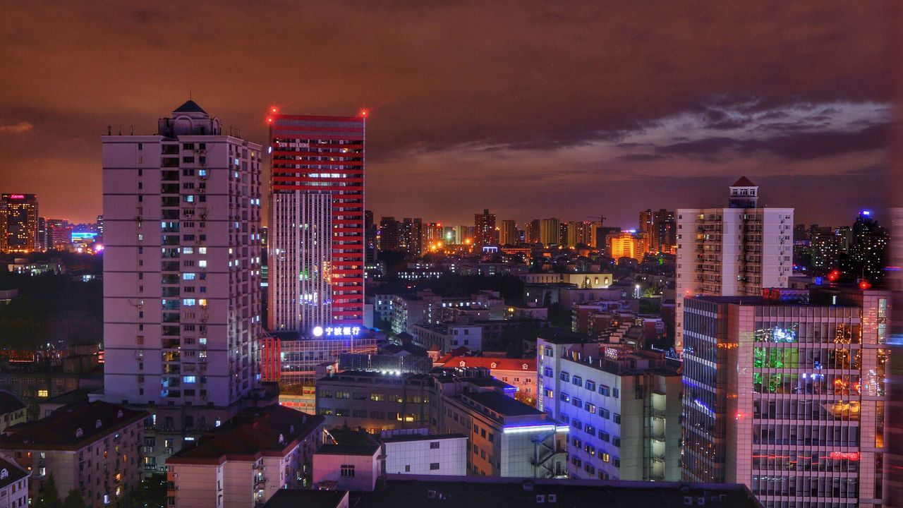 building exterior, illuminated, architecture, city, built structure, night, cityscape, sky, skyscraper, modern, tower, office building, residential building, tall - high, cloud - sky, city life, urban skyline, dusk, residential structure, residential district