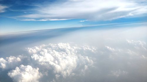 Aerial view of clouds over sea against sky