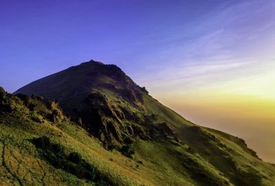 Countryside landscape against mountain range