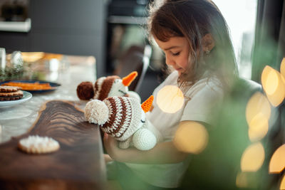 Woman holding toy at home