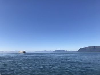 Scenic view of sea against clear blue sky