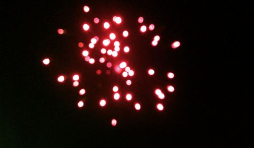 Close-up of illuminated firework display against black background