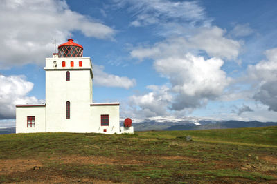 Lighthouse against cloudy sky