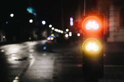 Close-up of illuminated road signal at night