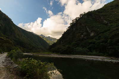 Scenic view of mountains against cloudy sky