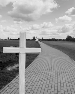 View of cross against cloudy sky