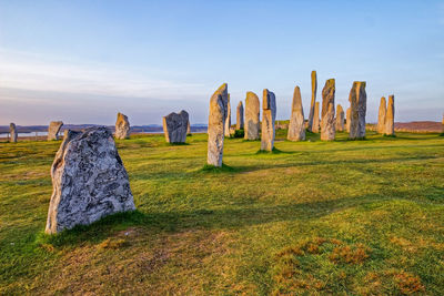 Panoramic view of rocks on field against sky