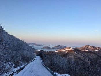 Scenic view of snow covered mountains against sky