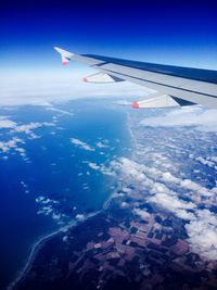 Cropped image of airplane flying over landscape