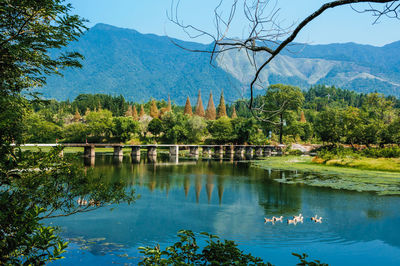 Scenic view of lake and mountains against sky